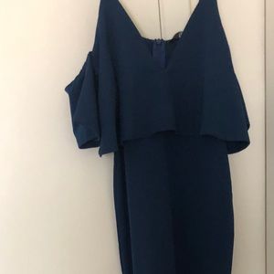 Long blue dress with ruffle sleeves.